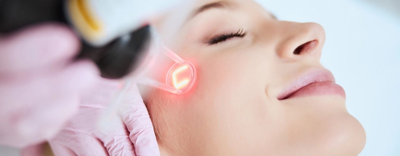 happy female getting laser treatment on face